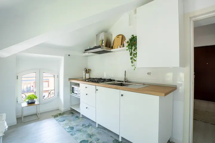 White fully equipped kitchen under a skylight