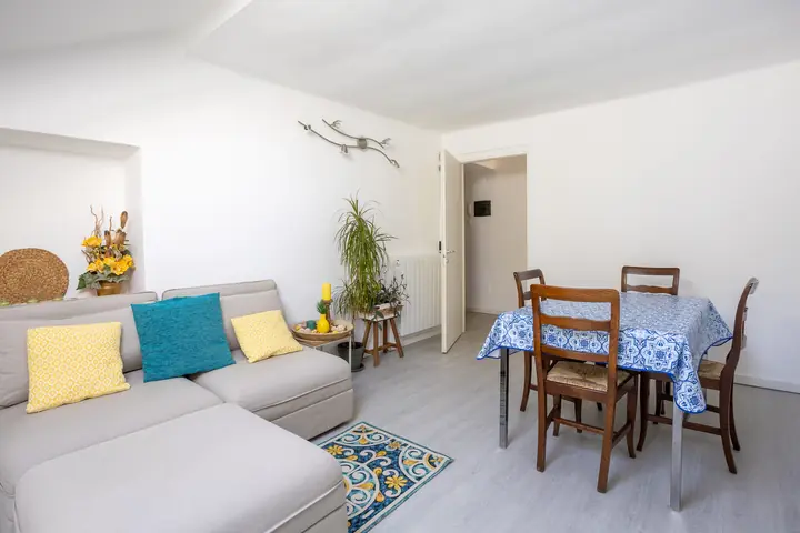 Living room with a sofa and dining table